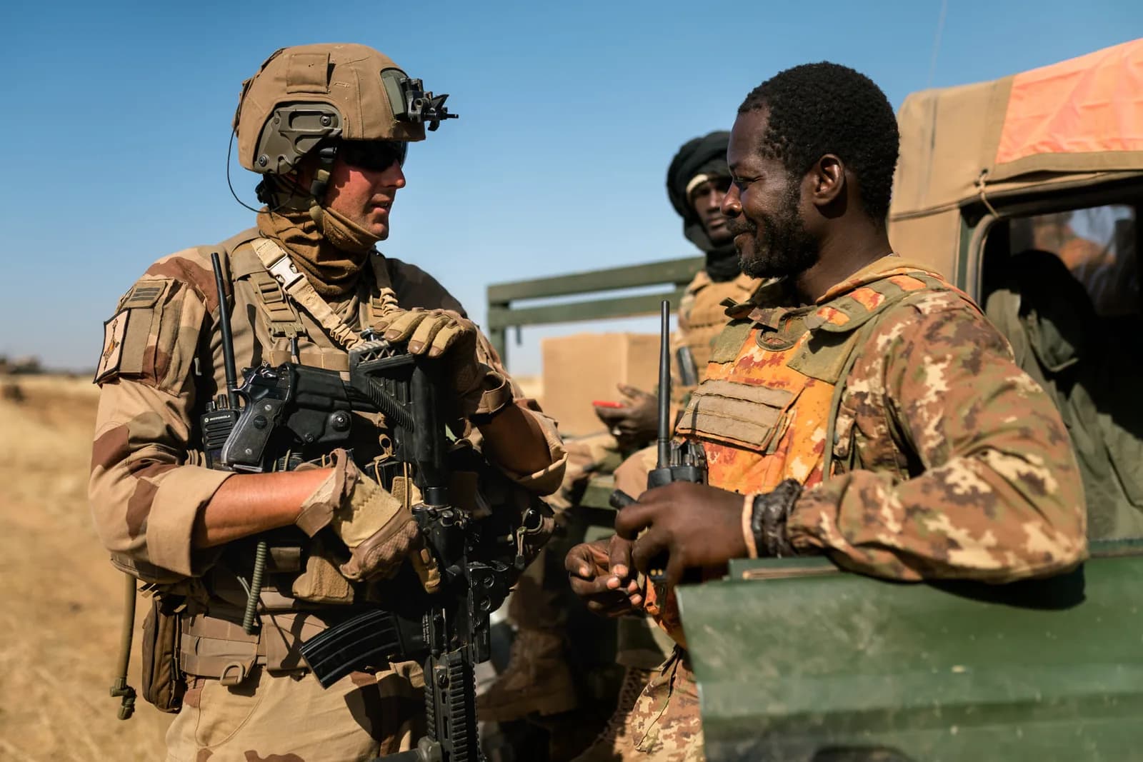 Officier français en camouflage Daguet échangeant avec un soldat malien, opération Barkhane